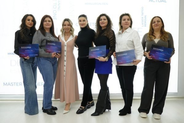 Graduates holding their completion diplomas